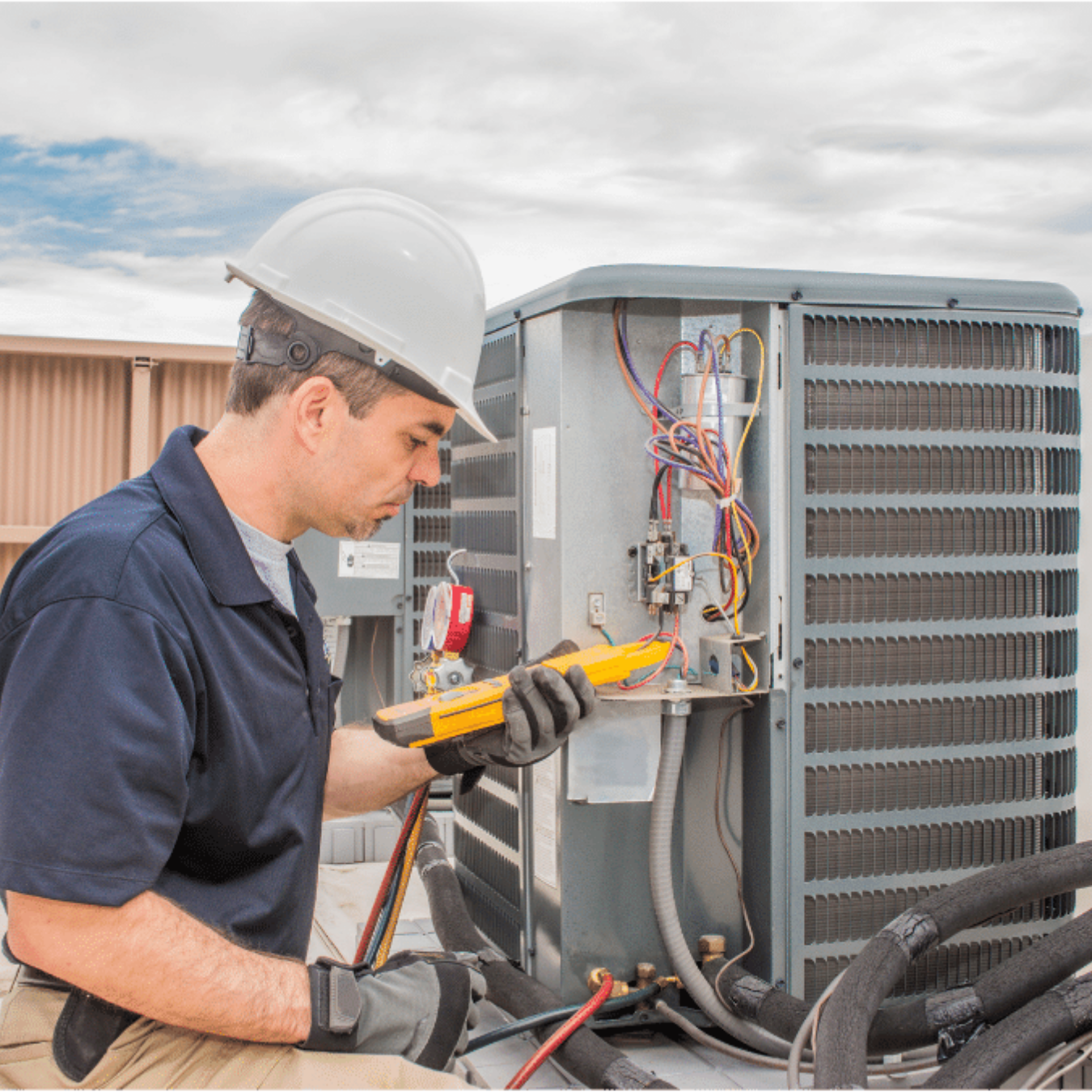 Kitchener AC Repair HVAC technician servicing a system